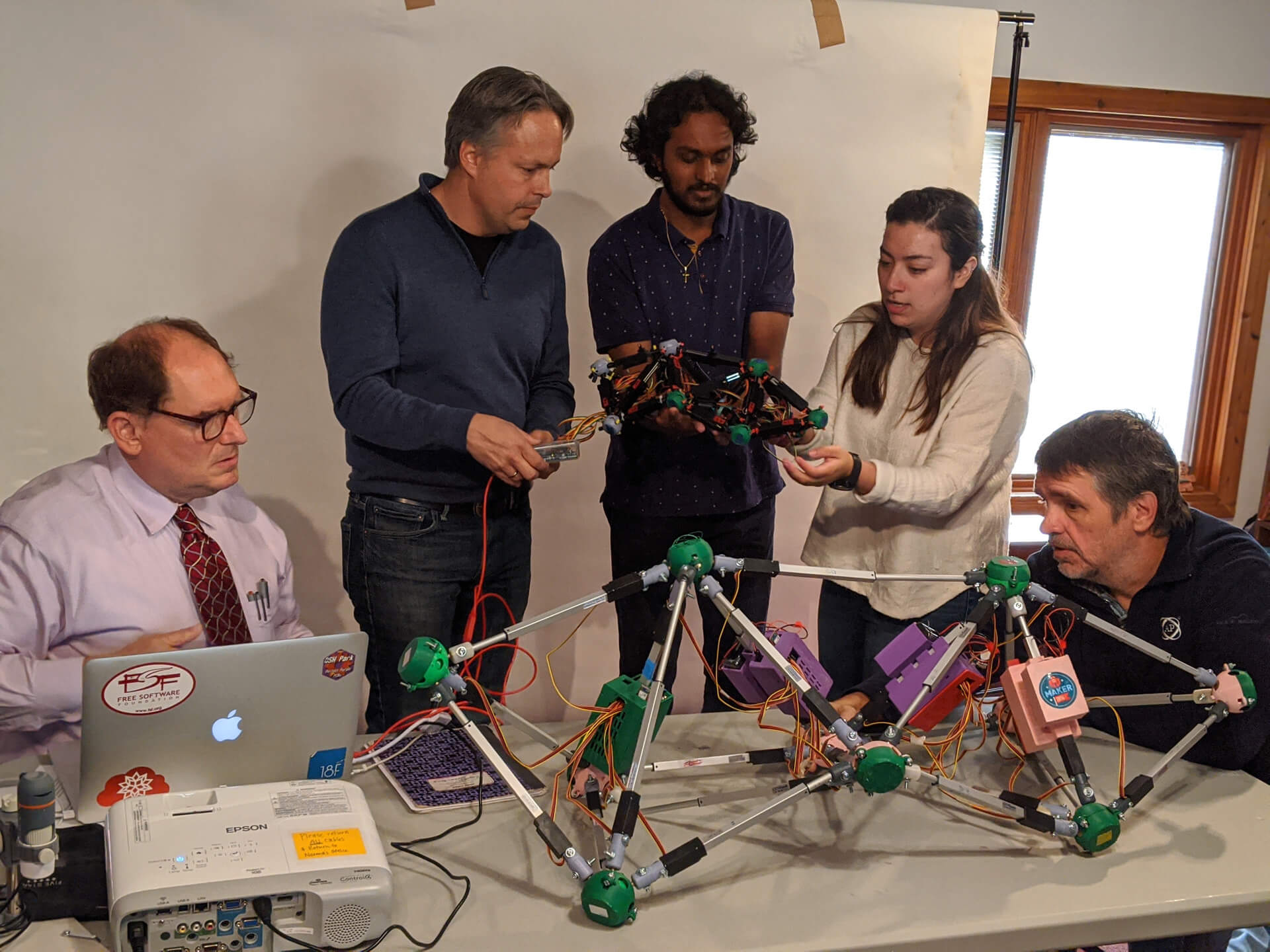 Megan holding a controller while collaborating with other inventors.